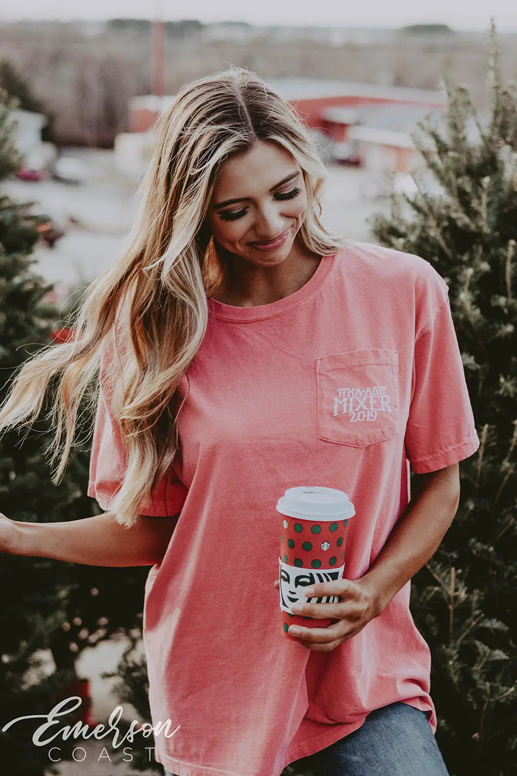 Girl wears a red tshirt with Pi Kappa Alpha and ADPi letters on it featuring a picture of the Grinch in various holiday attire.