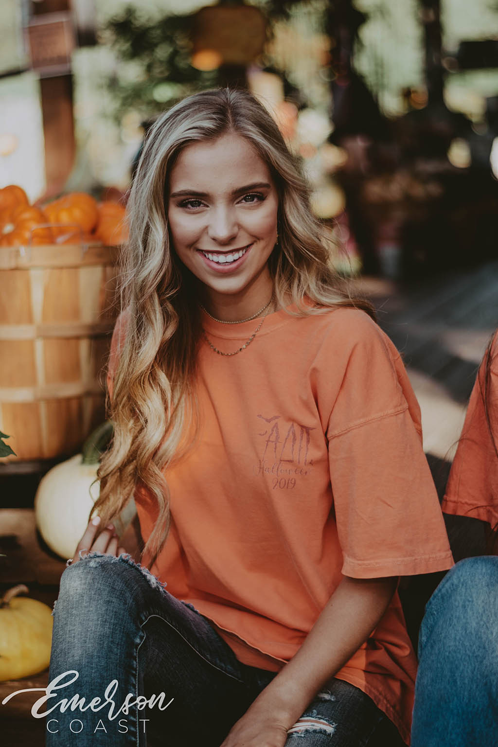 Girl wears orange ADPi Halloween Tshirt featuring a picture of a lion wearing a witch hat.