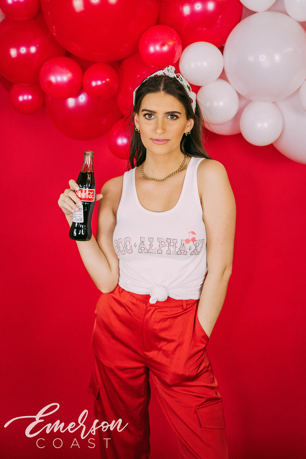 Girl wears white tank with 1-800-Alpha-Xi written across it.